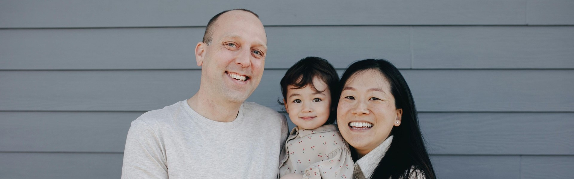 Large picture of a family holding their daughter