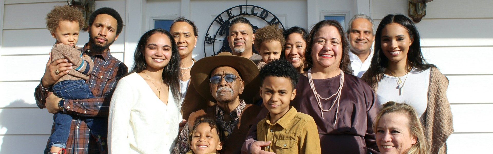 Large picture of a family standing in front of their home