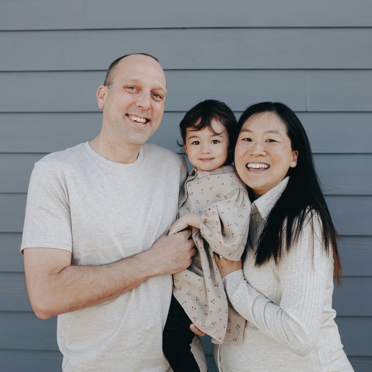 Small picture of a family holding their daughter